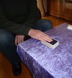 Client putting cards back down on table